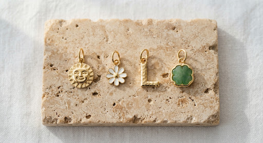A collection of gold keepsake charms